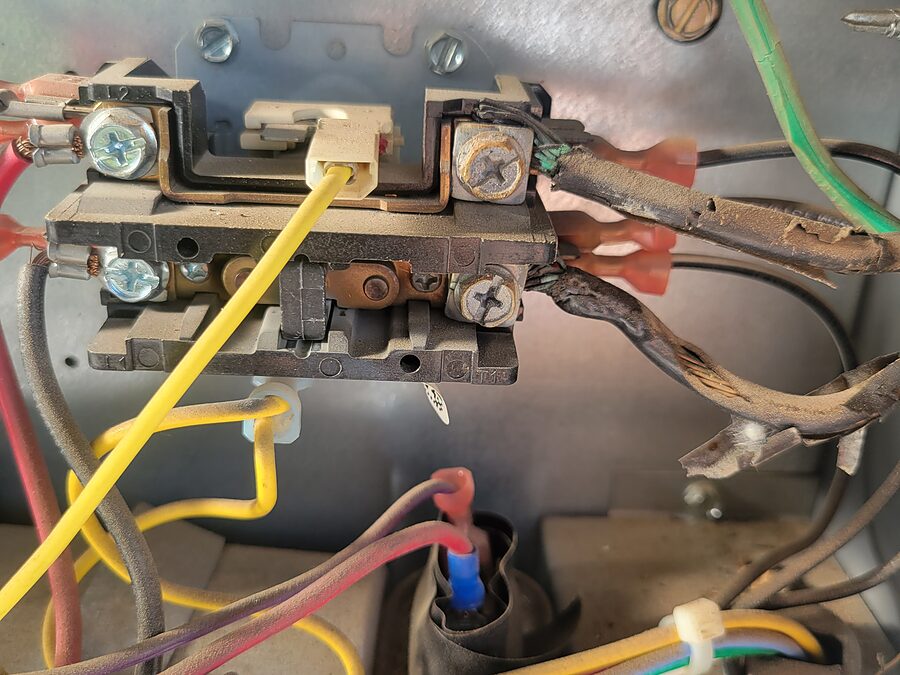 Burned contactor wiring checked during AC electrical diagnostics