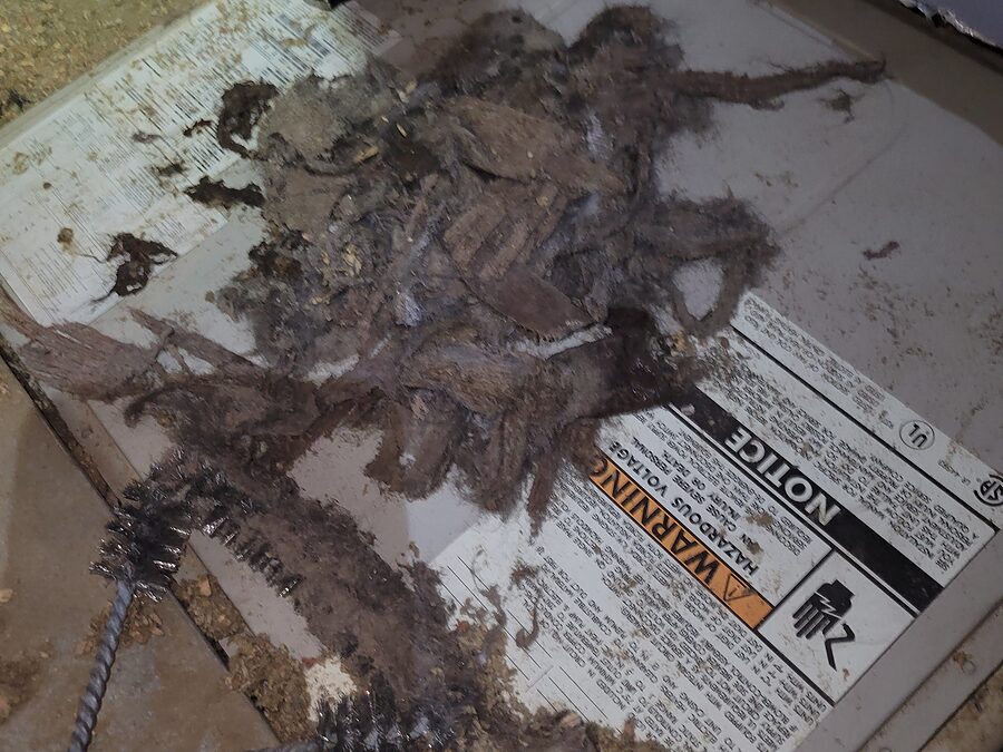 Dust and debris inside HVAC equipment checked when material near hot parts causes a burning smell