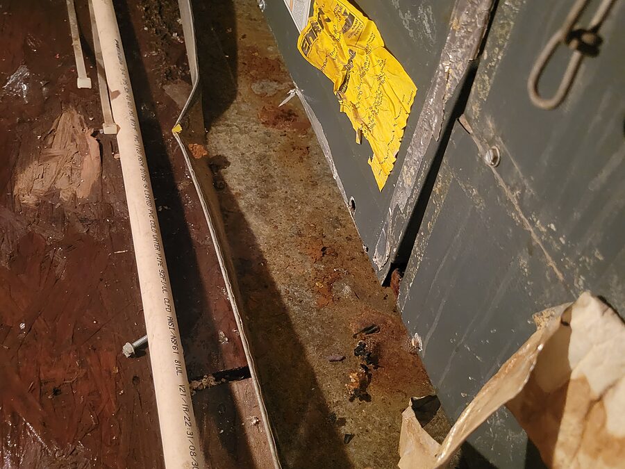 Rust and staining in AC drain pan area during leak diagnostics