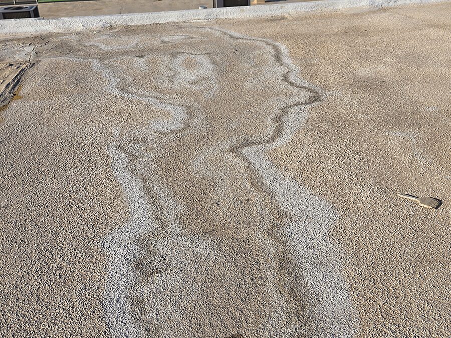 Rooftop water staining from AC drain discharge showing drain leak concerns