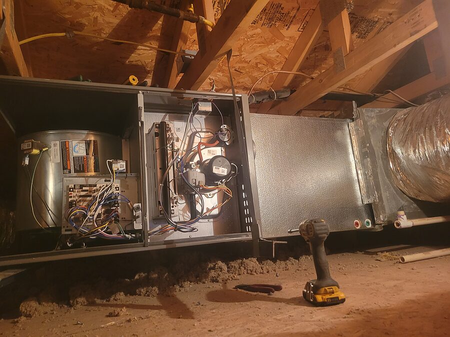 Open attic air handler blower and duct area checked for indoor AC noise