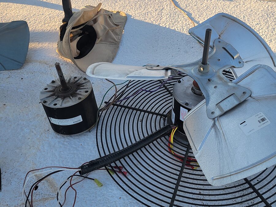 Removed condenser fan motor and fan parts checked during AC noise diagnostics