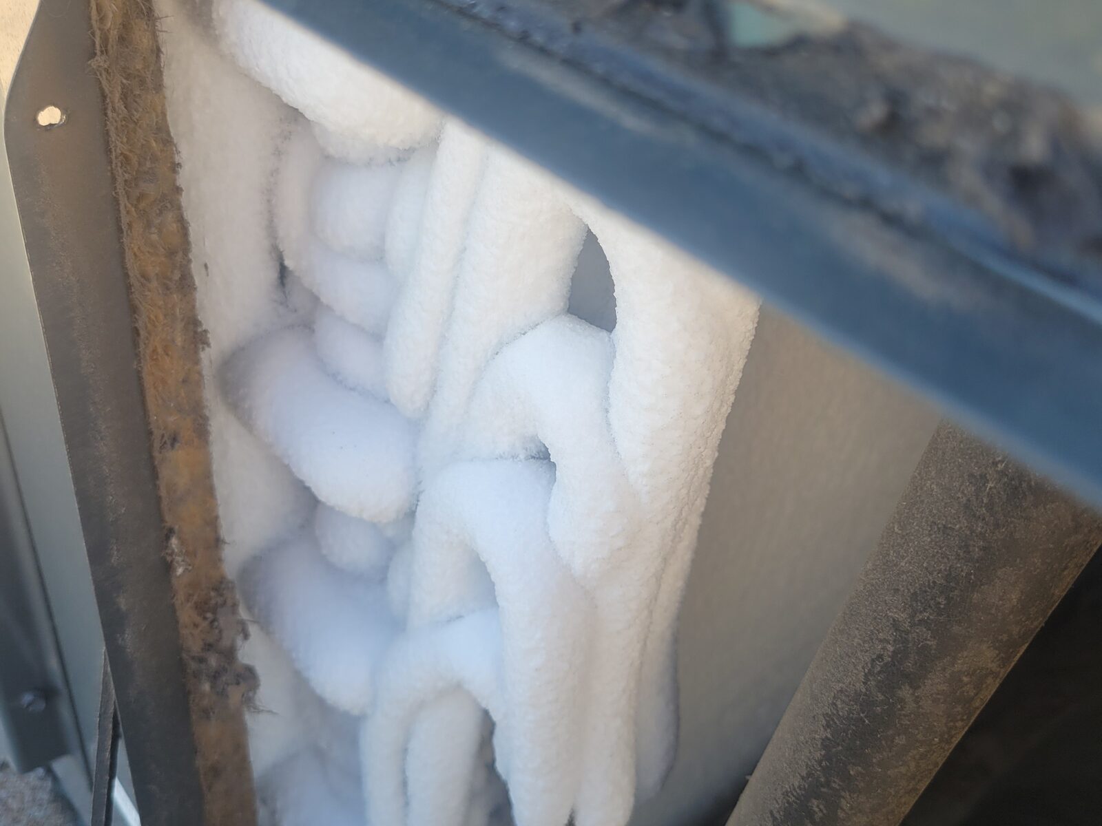 Frozen evaporator coil ice checked during AC no-cooling diagnostics