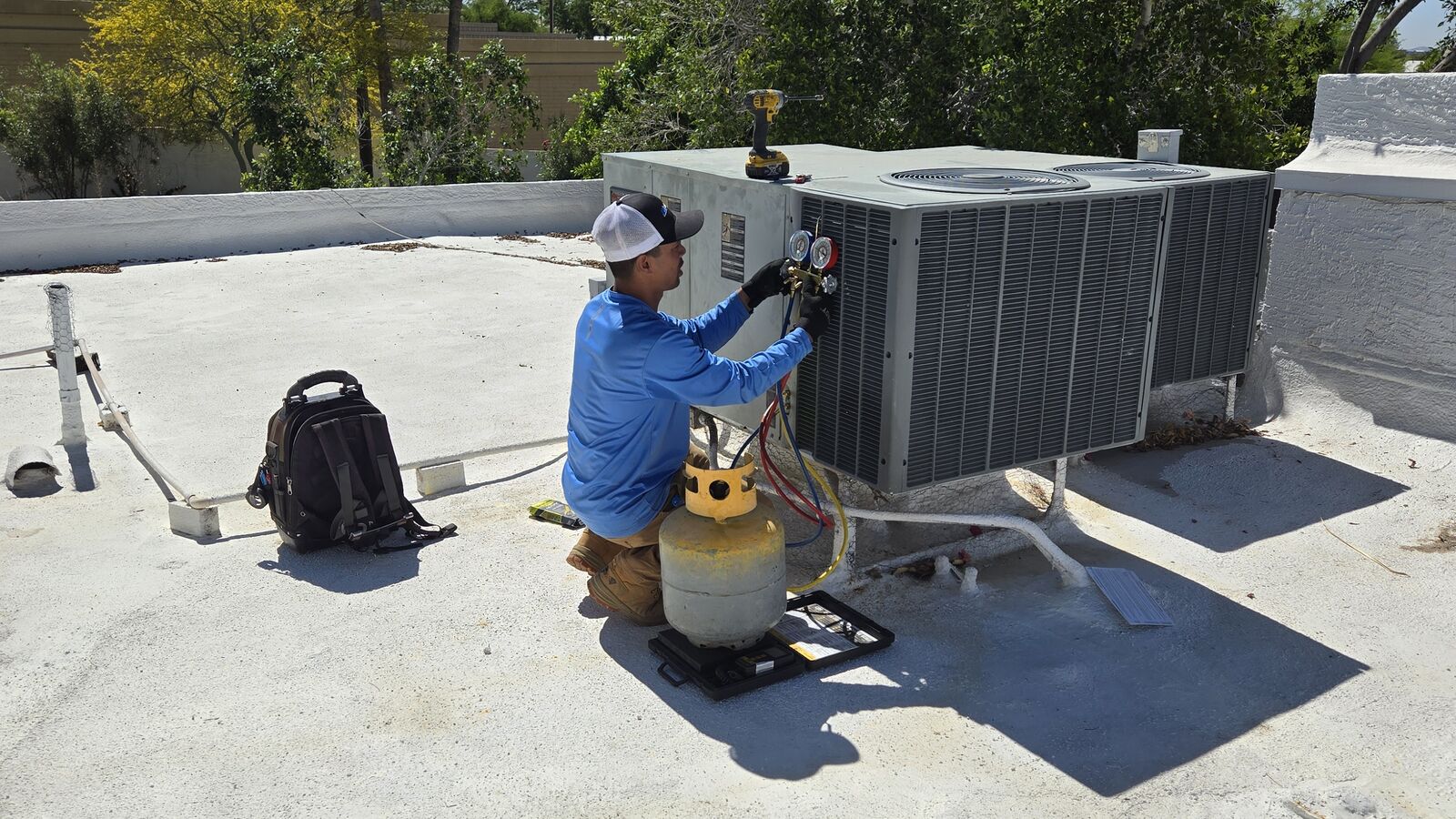 Outdoor AC equipment checked during no-cooling emergency repair in Phoenix heat