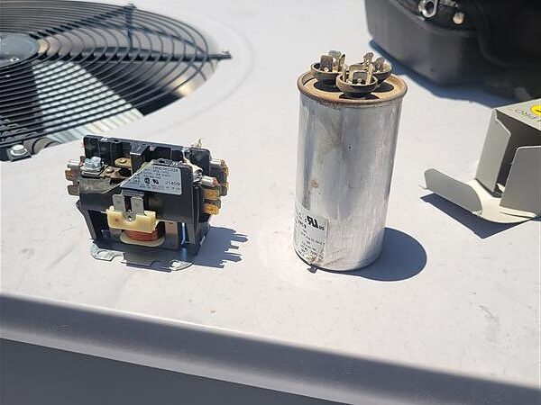 HVAC contactor and capacitor on rooftop unit during outdoor AC humming diagnostics