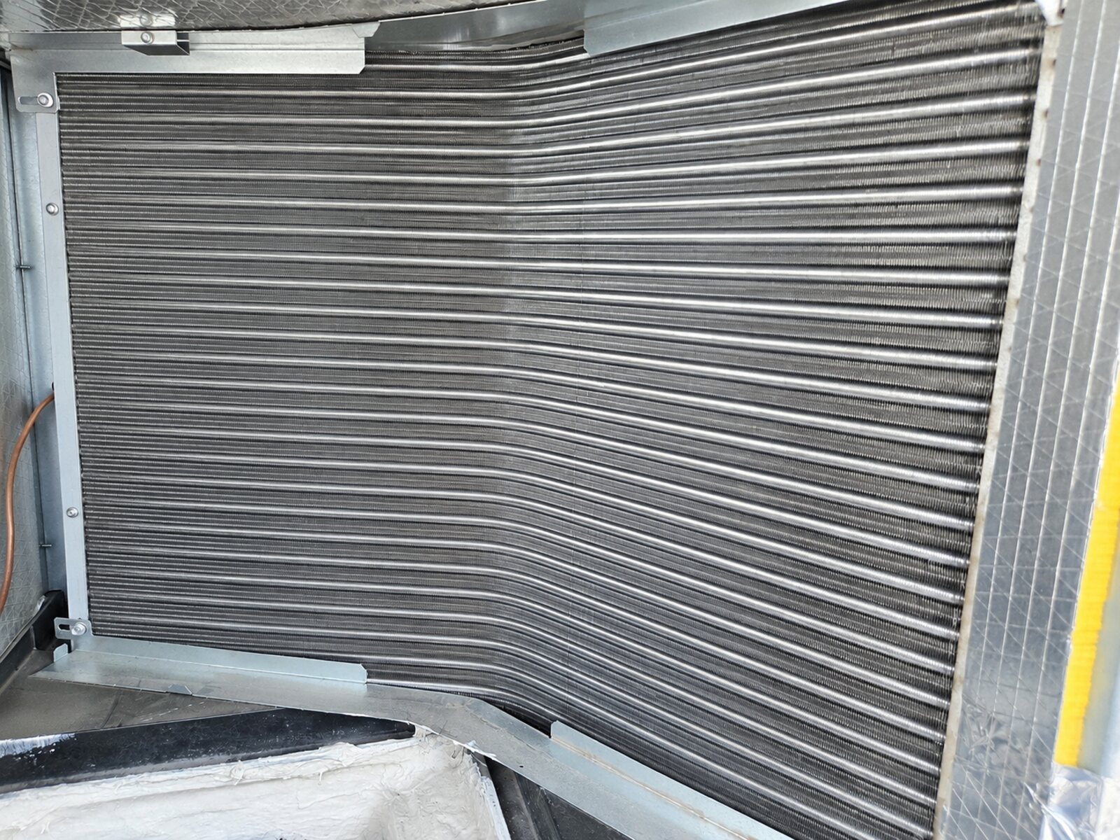 Clean evaporator coil surface during AC maintenance inspection