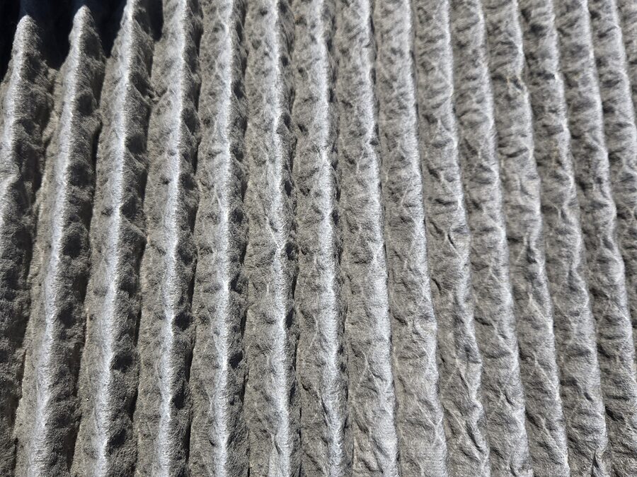 Dirty air filter checked during blower motor and airflow maintenance
