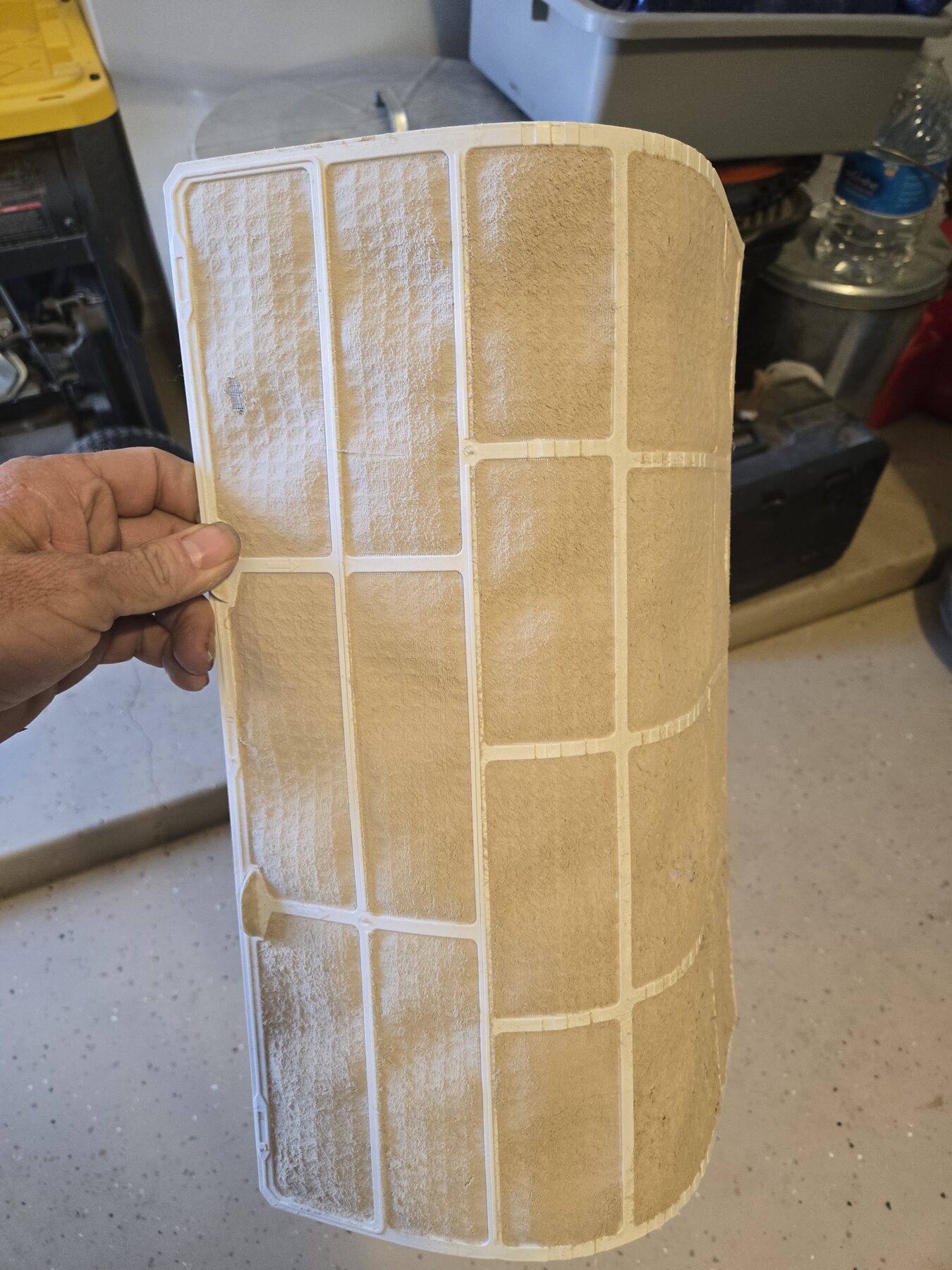Dirty air filter held during air conditioning service