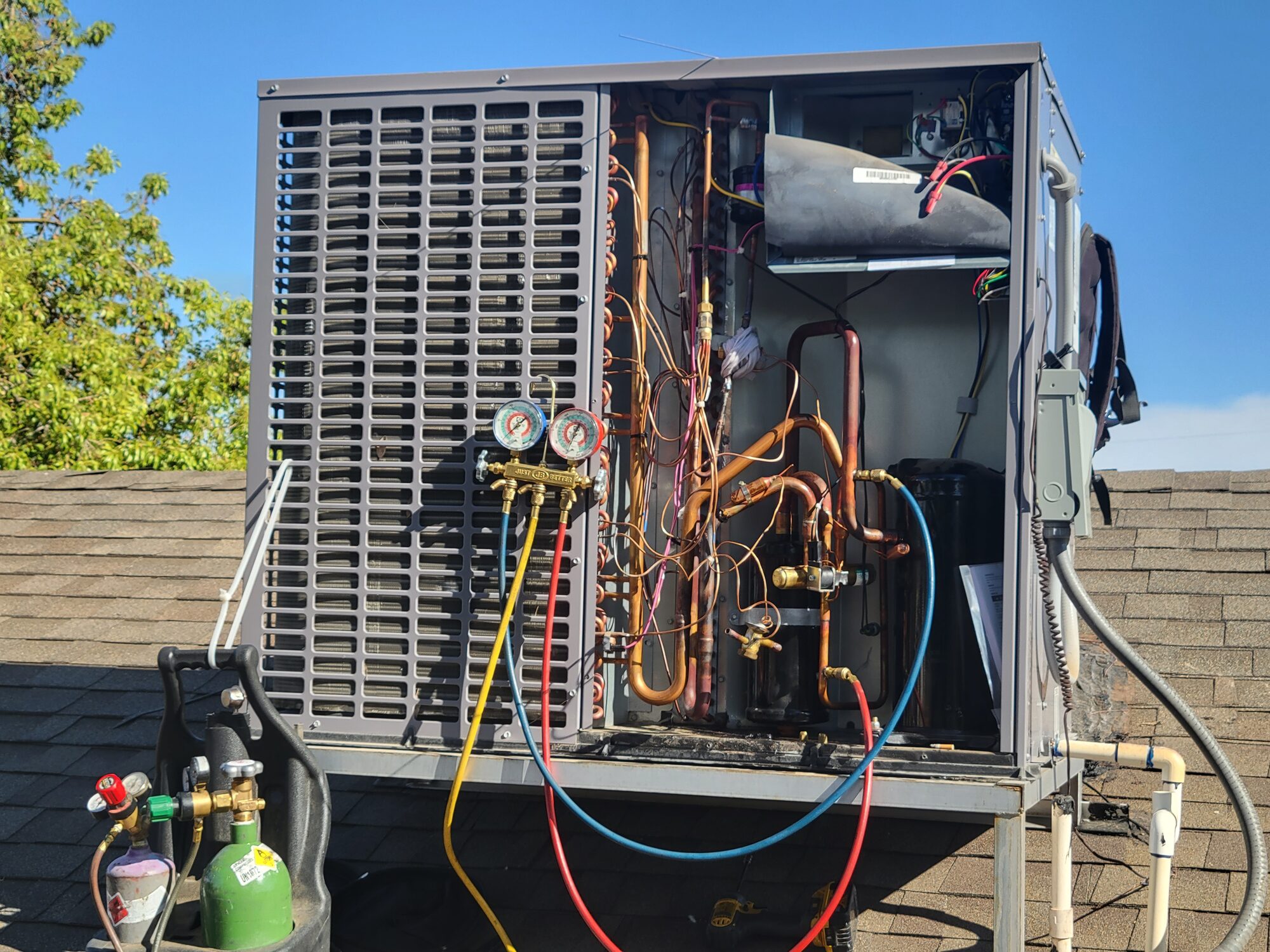 CTS technician at outdoor AC equipment during urgent summer repair call