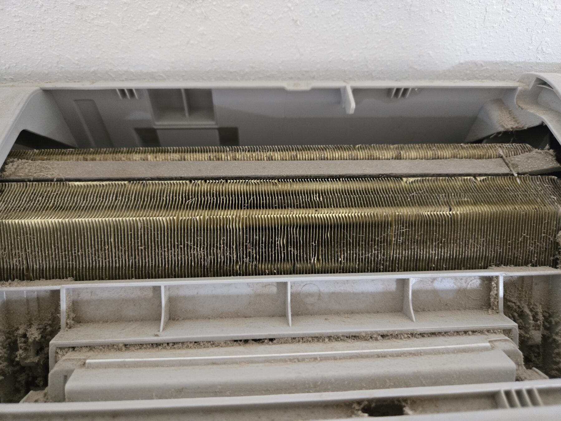 Open evaporator coil panel showing coil surface