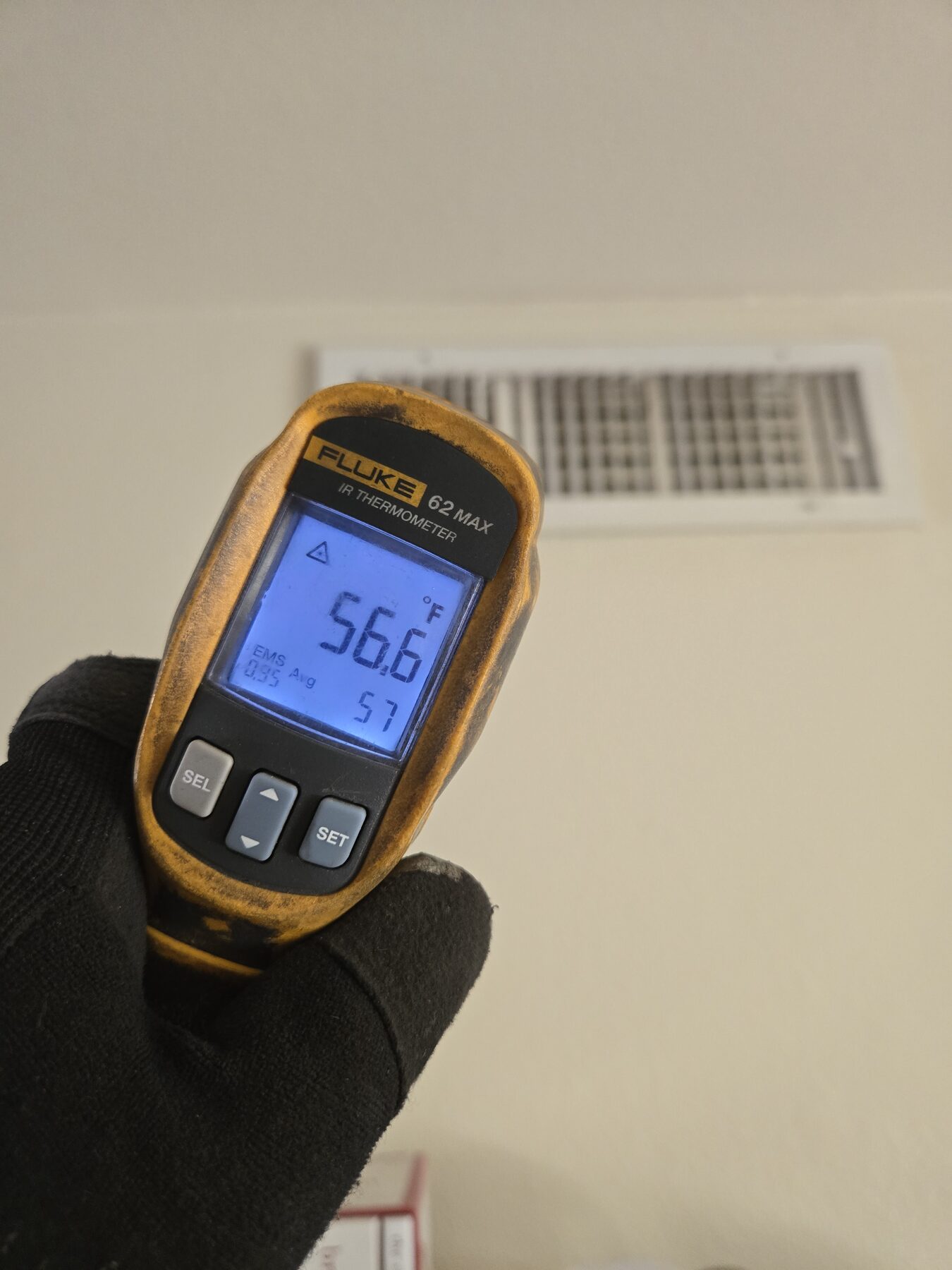 Infrared thermometer checking air conditioning supply temperature