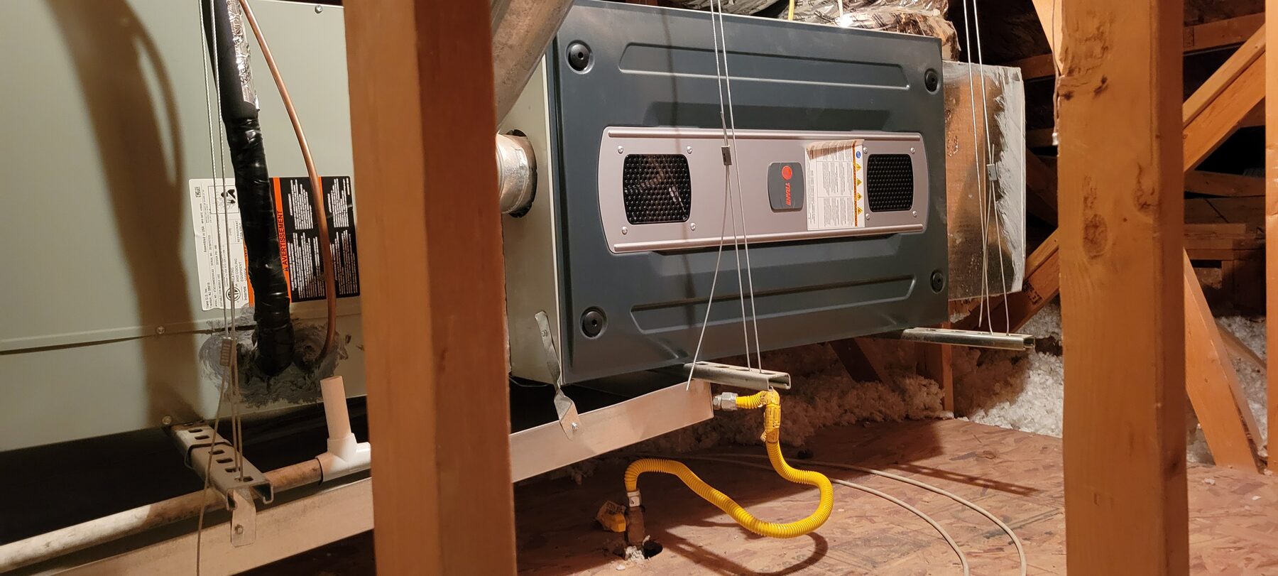 Furnace equipment in an attic with gas line visible