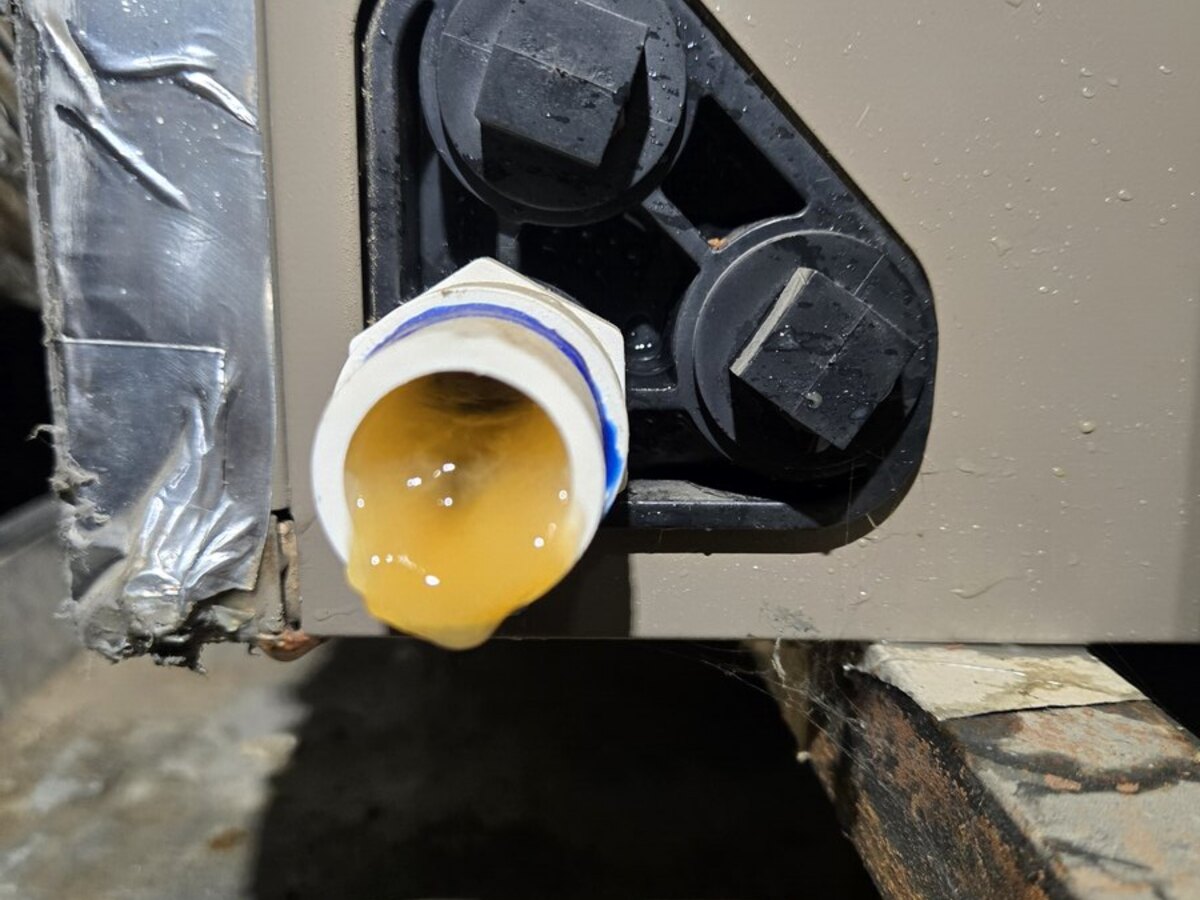 HVAC condensate trap with standing water during AC leak diagnostics