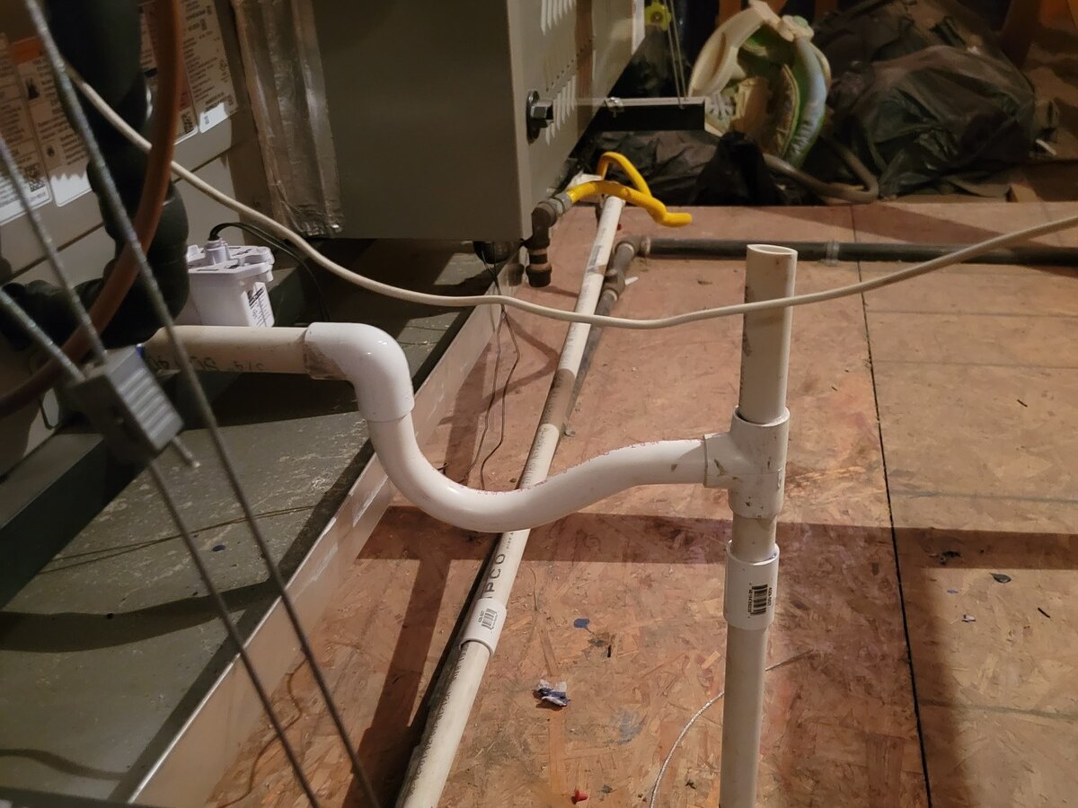 Air handler condensate drain piping in an attic mechanical space