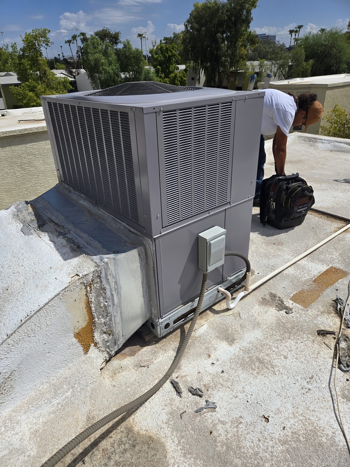Leon working on rooftop HVAC equipment