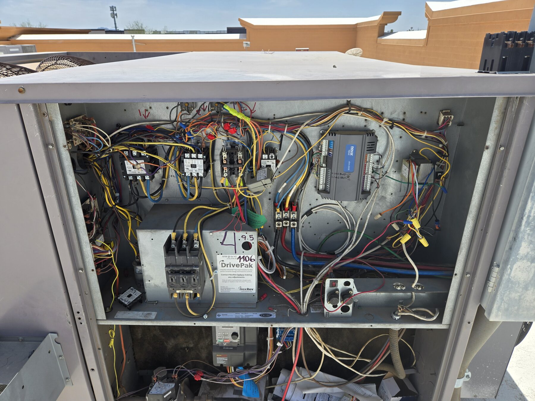 Open HVAC electrical panel with wiring and components visible