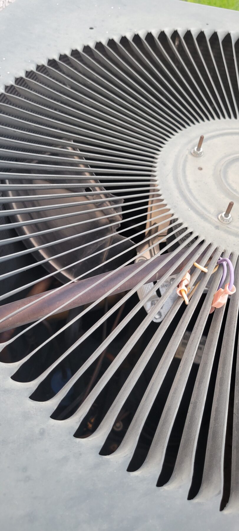 Outdoor condenser fan motor and fan blade viewed from above