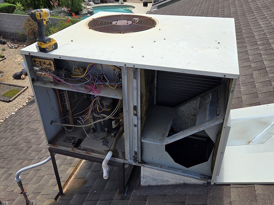 Older outdoor condenser checked during short cycling repair or replacement discussion