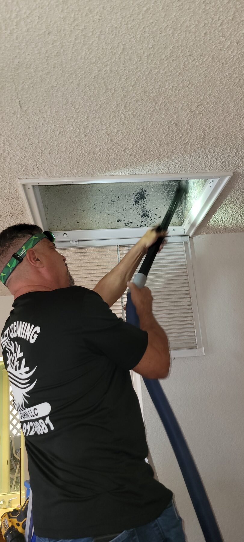 Technician checking return vent and airflow during AC service