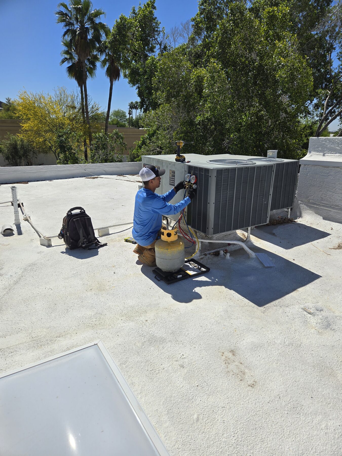 Technician working on rooftop HVAC equipment during diagnostic service