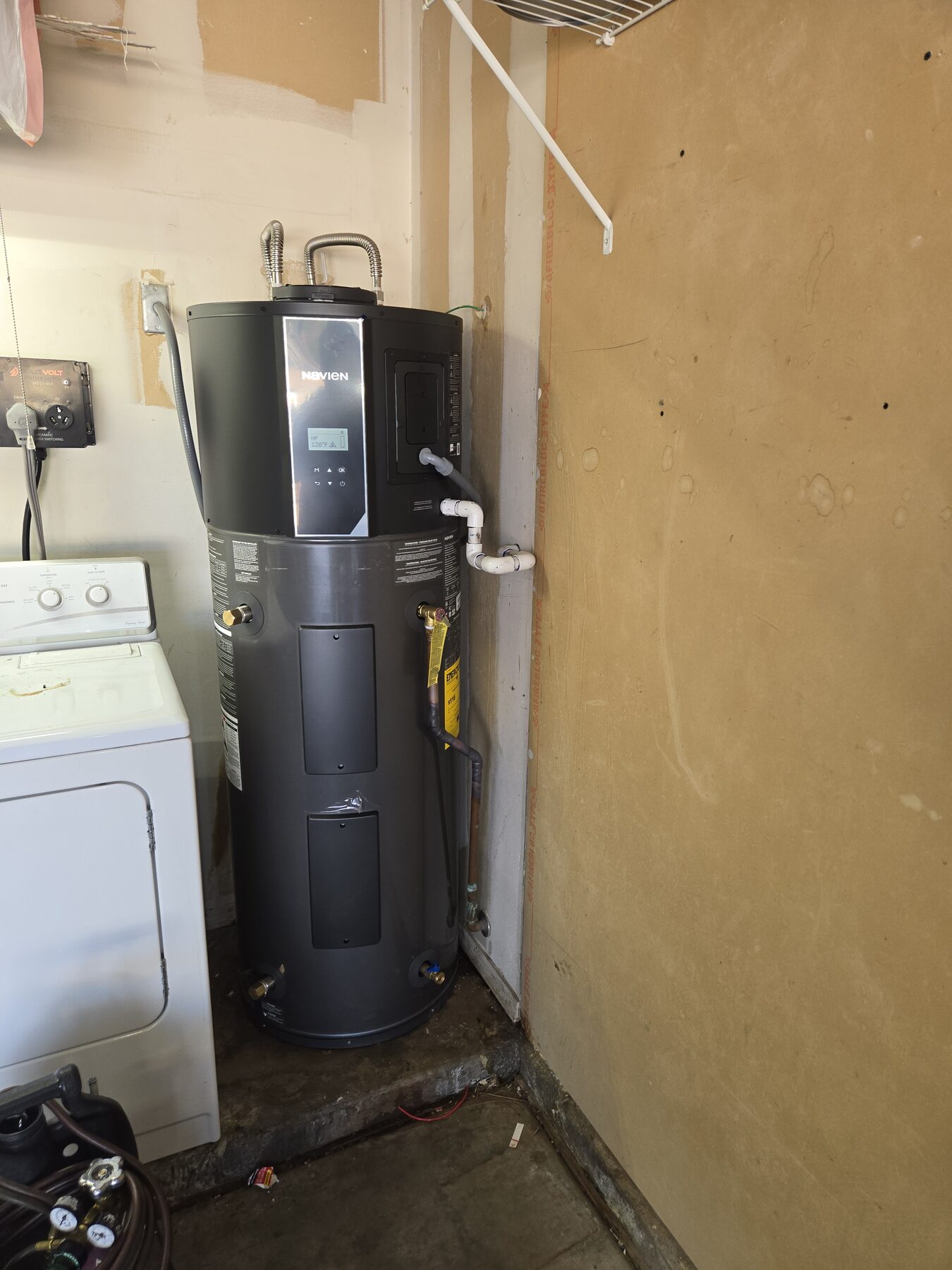 Clean tankless water heater installed in a laundry area