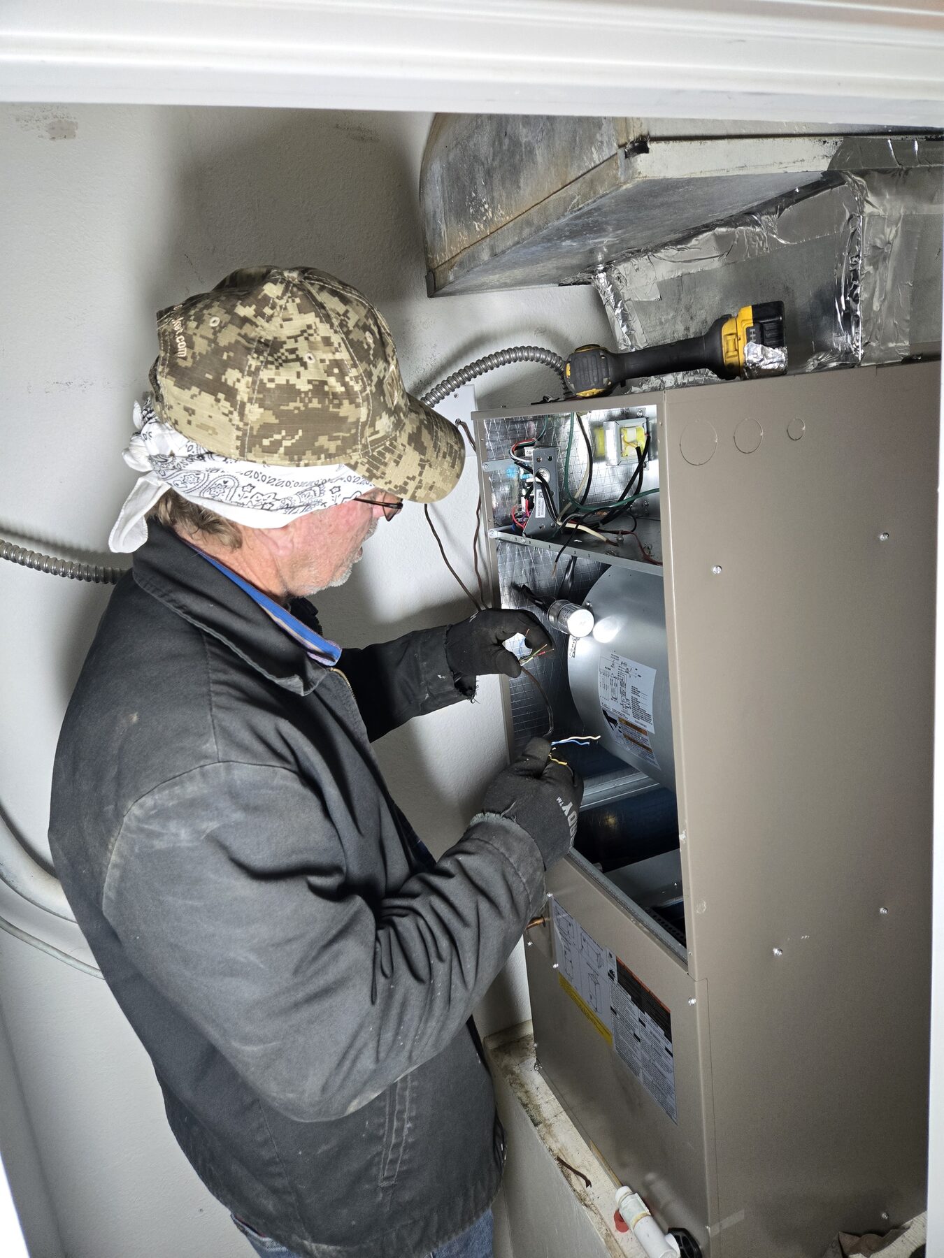 Technician servicing indoor furnace or air handler equipment