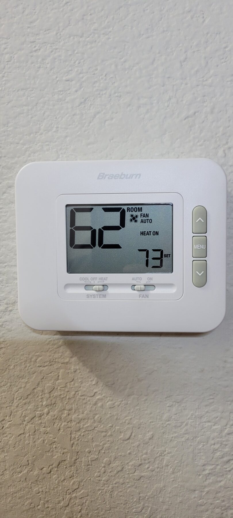 Wall thermostat display showing indoor temperature