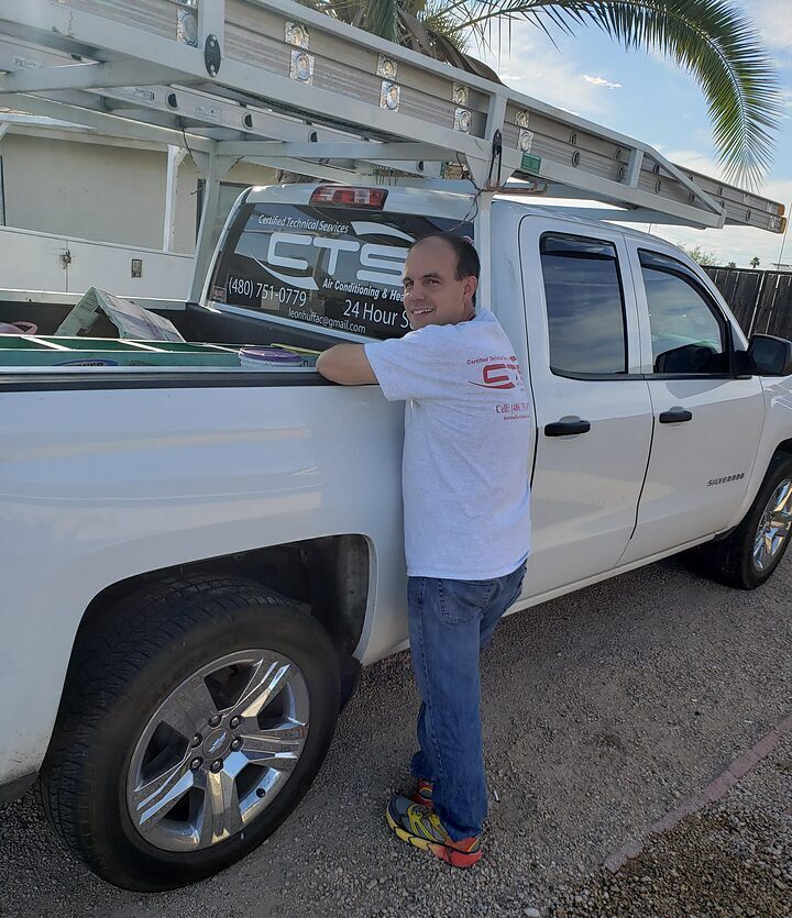 Tony Aimonetti standing beside a CTS Air Conditioning service truck