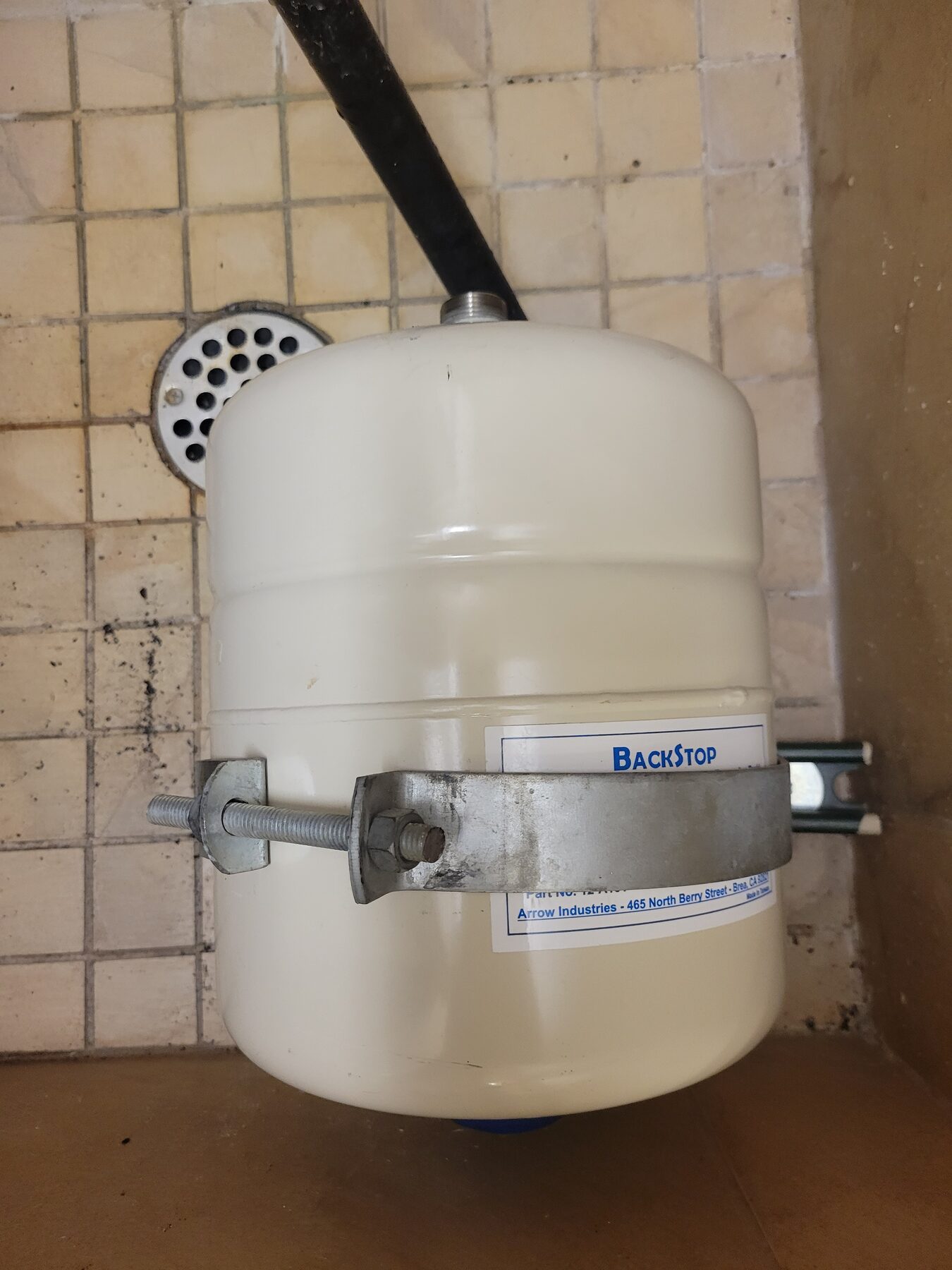 Water heater expansion tank installed above plumbing