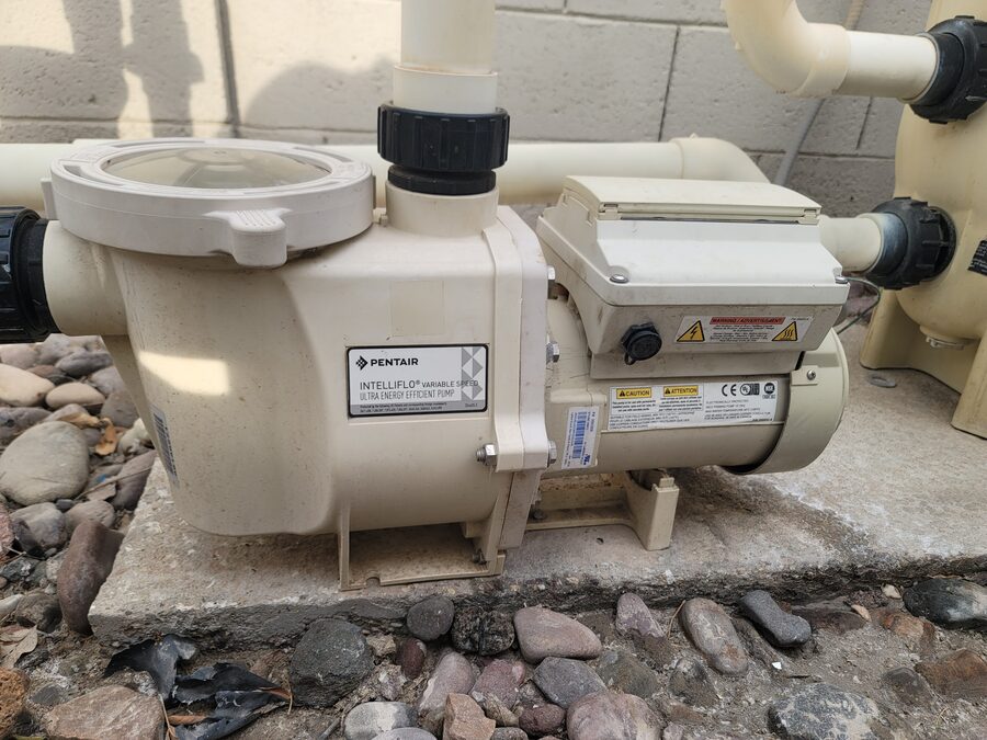 Pool pump equipment pad with PVC plumbing, unions, and pump connections