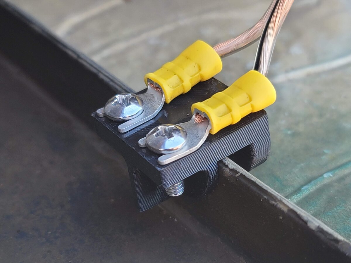 Drain pan water sensor mounted on the edge of an HVAC drain pan